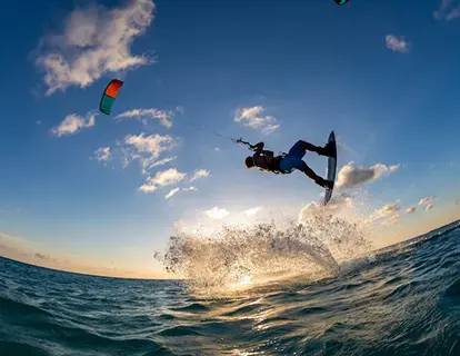 Kitesurfer jumping at sunset
