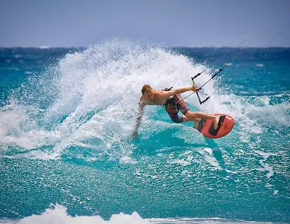 Kitesurfer riding a wave